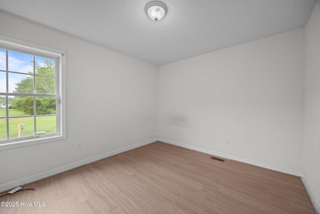 1218 Early Station Rd, Aulander, NC 27805 - spare room featuring healthy amount of natural light, light wood-style floors, and a textured ceiling