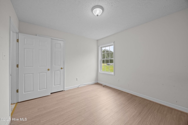 1218 Early Station Rd, Aulander, NC 27805 - unfurnished bedroom with light wood finished floors and a textured ceiling
