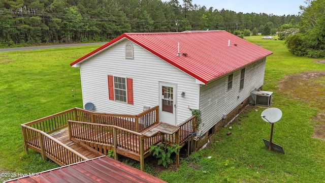 1218 Early Station Rd, Aulander, NC 27805 - back of house with a wooded view, a deck, a lawn, and a metal roof