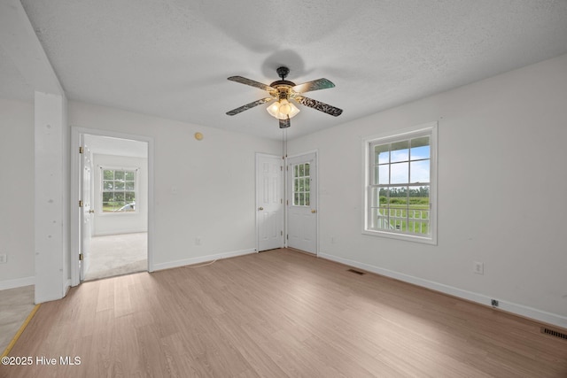 1218 Early Station Rd, Aulander, NC 27805 - spare room featuring light wood-style flooring, a ceiling fan, and a textured ceiling