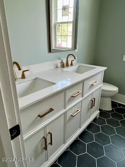700 Bertram Ct, Hampstead, NC 28443 - bathroom featuring double vanity and tile patterned flooring