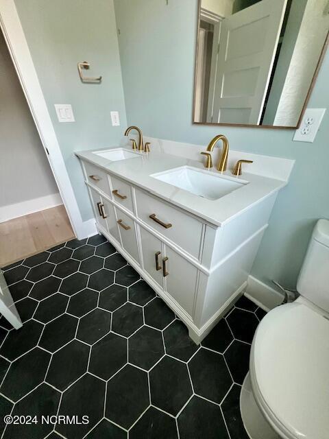 700 Bertram Ct, Hampstead, NC 28443 - bathroom featuring double vanity and tile patterned flooring