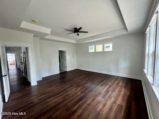 700 Bertram Ct, Hampstead, NC 28443 - unfurnished room with a tray ceiling, ceiling fan, and dark wood finished floors
