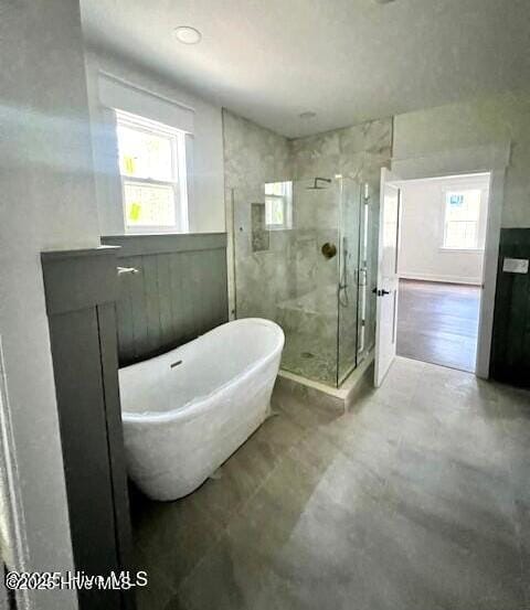 700 Bertram Ct, Hampstead, NC 28443 - full bathroom featuring a shower stall and a freestanding tub