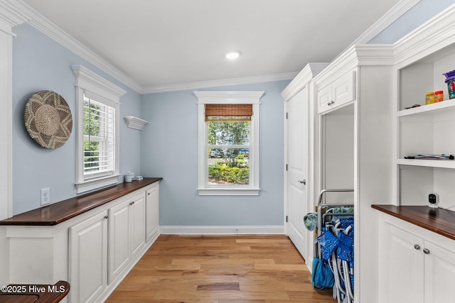 125 NE 13th St, Oak Island, NC 28465 - laundry room featuring light wood-style flooring, ornamental molding, plenty of natural light, and recessed lighting