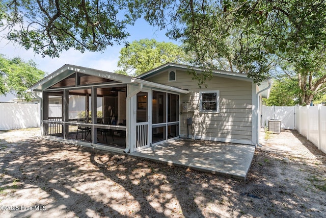 125 NE 13th St, Oak Island, NC 28465 - rear view of property with a sunroom and a fenced backyard