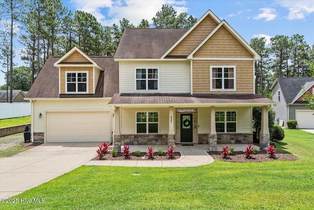 621 Longleaf Rd, Aberdeen, NC 28315 - craftsman house with concrete driveway, covered porch, stone siding, and a shingled roof