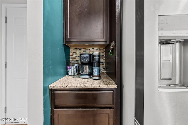 621 Longleaf Rd, Aberdeen, NC 28315 - kitchen with dark brown cabinetry, decorative backsplash, and light stone counters