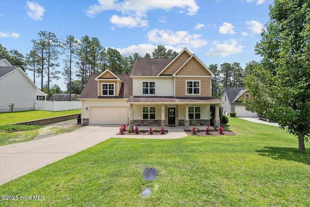 621 Longleaf Rd, Aberdeen, NC 28315 - craftsman-style house with covered porch, concrete driveway, stone siding, a front lawn, and a garage