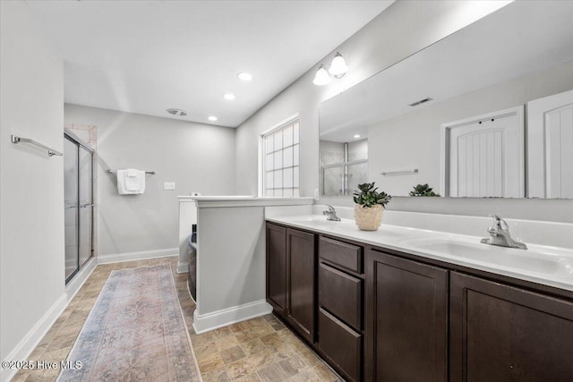 621 Longleaf Rd, Aberdeen, NC 28315 - full bath with double vanity, a stall shower, stone finish flooring, and recessed lighting