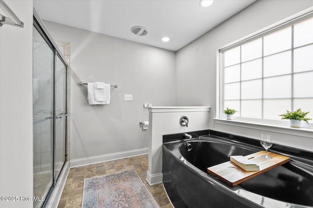 621 Longleaf Rd, Aberdeen, NC 28315 - full bathroom featuring a bath, a shower stall, stone finish floors, and recessed lighting