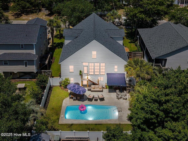 104 NE 27th St, Oak Island, NC 28465 - back of house featuring a shingled roof, outdoor lounge area, a fenced backyard, a patio, and outdoor dining space