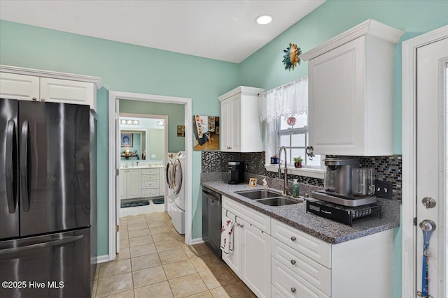 104 NE 27th St, Oak Island, NC 28465 - kitchen with freestanding refrigerator, washer and dryer, white cabinets, dishwashing machine, and recessed lighting
