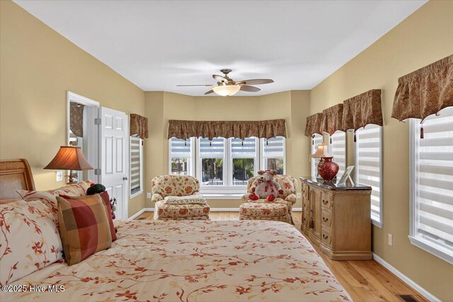 104 NE 27th St, Oak Island, NC 28465 - bedroom with light wood-style flooring and ceiling fan