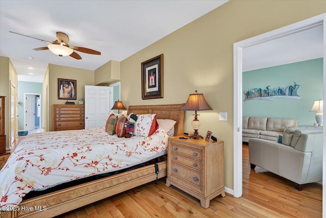 104 NE 27th St, Oak Island, NC 28465 - bedroom with light wood-style flooring and a ceiling fan