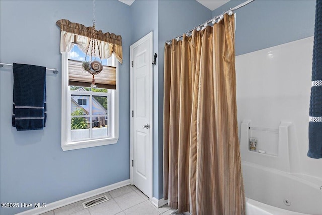 104 NE 27th St, Oak Island, NC 28465 - bathroom with tile patterned flooring and a combined bath / shower with jetted tub