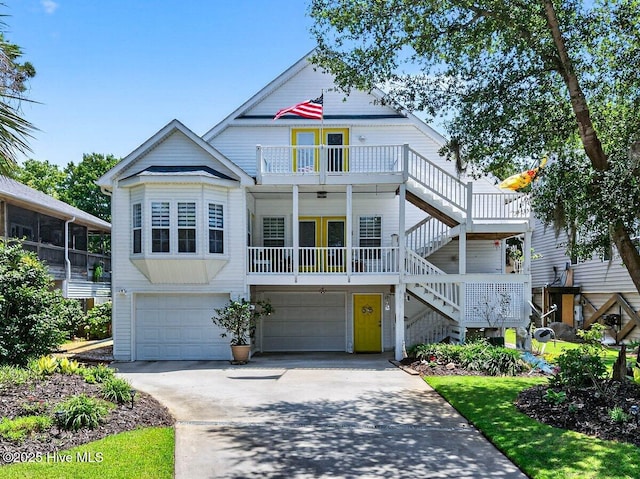 104 NE 27th St, Oak Island, NC 28465 - view of front of home featuring a garage, stairway, driveway, and a balcony
