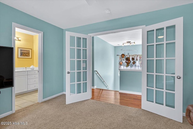 104 NE 27th St, Oak Island, NC 28465 - unfurnished room with light carpet, a smoke detector, and french doors