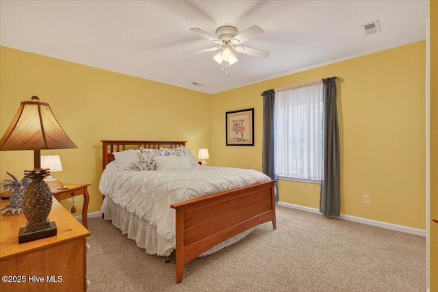 104 NE 27th St, Oak Island, NC 28465 - bedroom with light carpet and a ceiling fan