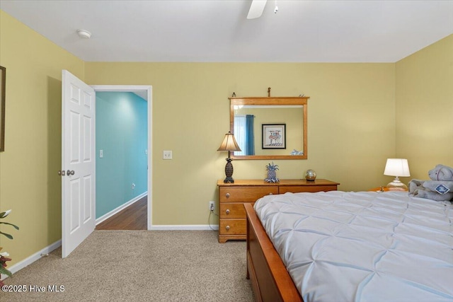 104 NE 27th St, Oak Island, NC 28465 - carpeted bedroom with baseboards and a ceiling fan