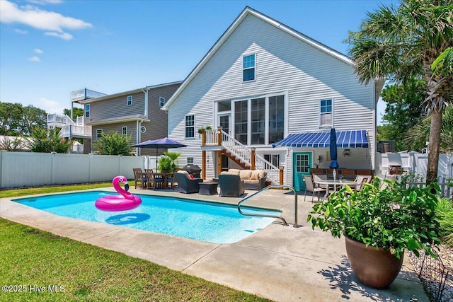 104 NE 27th St, Oak Island, NC 28465 - view of swimming pool featuring an outdoor hangout area, a fenced backyard, stairway, and outdoor dining area