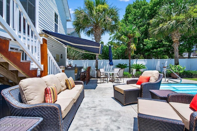 104 NE 27th St, Oak Island, NC 28465 - fenced backyard with outdoor lounge area, outdoor dining area, a patio, and stairway