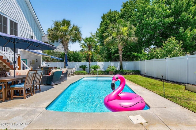 104 NE 27th St, Oak Island, NC 28465 - view of swimming pool featuring a fenced backyard, a patio area, outdoor dining space, and outdoor lounge area