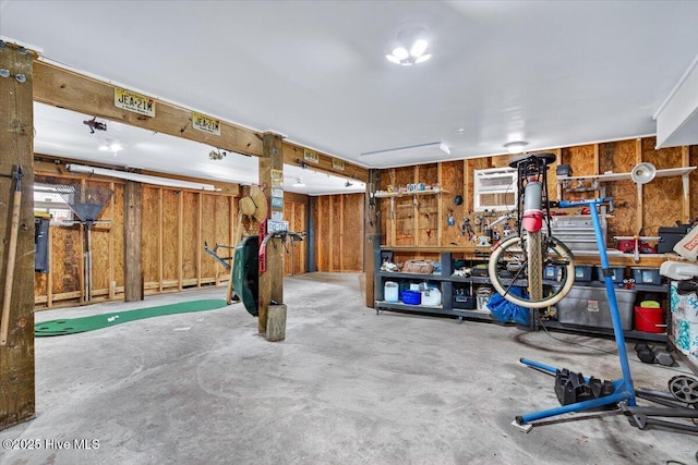 104 NE 27th St, Oak Island, NC 28465 - garage featuring wooden walls and a wall unit AC