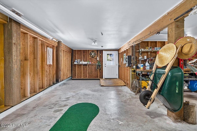 104 NE 27th St, Oak Island, NC 28465 - miscellaneous room featuring unfinished concrete floors and wooden walls