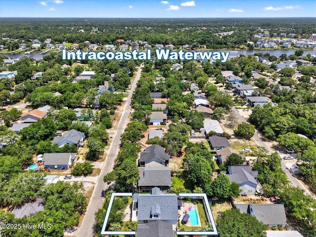104 NE 27th St, Oak Island, NC 28465 - aerial perspective of suburban area featuring property parcel outlined and a nearby body of water