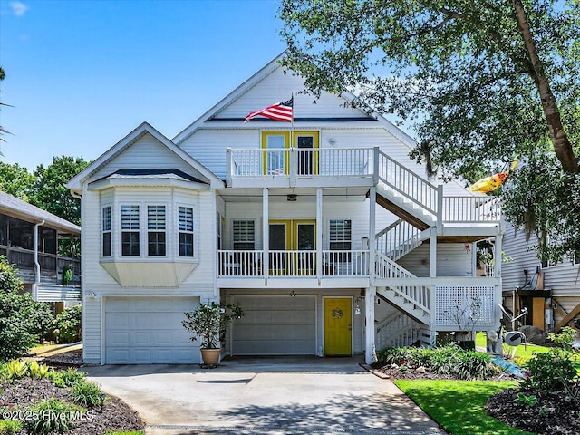 104 NE 27th St, Oak Island, NC 28465 - view of front of house with stairway, a garage, driveway, and a balcony
