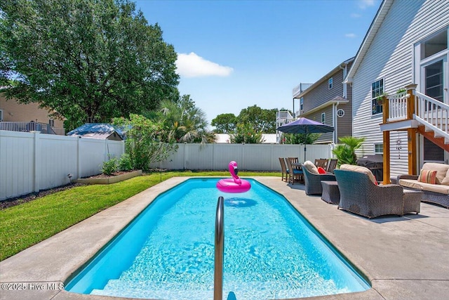 104 NE 27th St, Oak Island, NC 28465 - view of swimming pool featuring outdoor lounge area, a fenced backyard, and a patio
