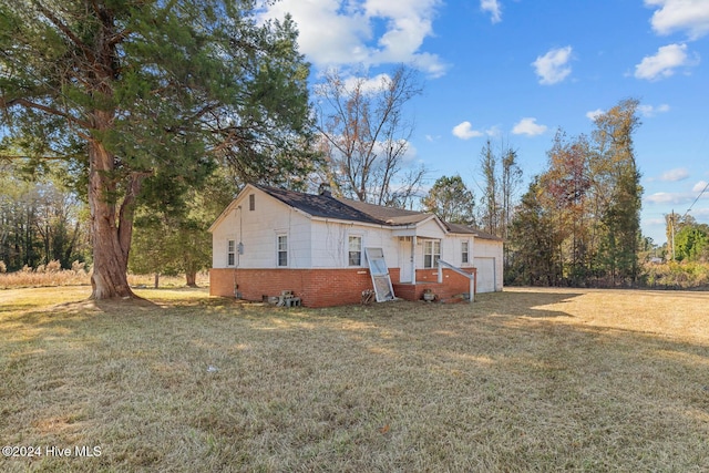 9626 NC Highway 50, Maple Hill, NC 28454 - view of property exterior with a garage and a lawn