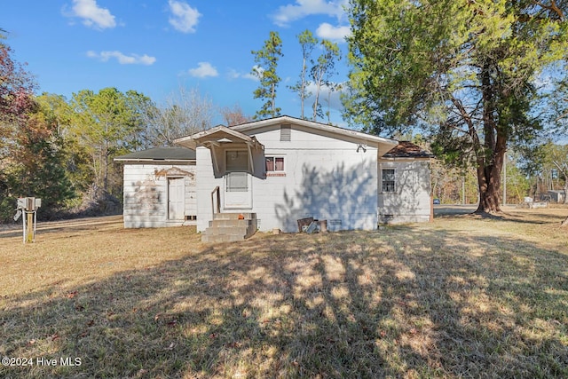 9626 NC Highway 50, Maple Hill, NC 28454 - view of front facade with concrete block siding, a front lawn, and entry steps