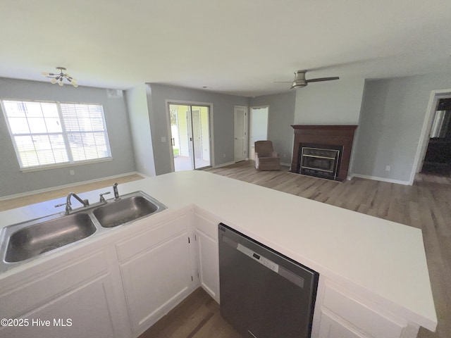 2940 Mulberry Ln Unit B, Greenville, NC 27858 - kitchen with dishwasher, a ceiling fan, open floor plan, a fireplace, and white cabinets