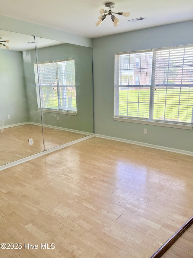 2940 Mulberry Ln Unit B, Greenville, NC 27858 - unfurnished bedroom with multiple windows and light wood-type flooring