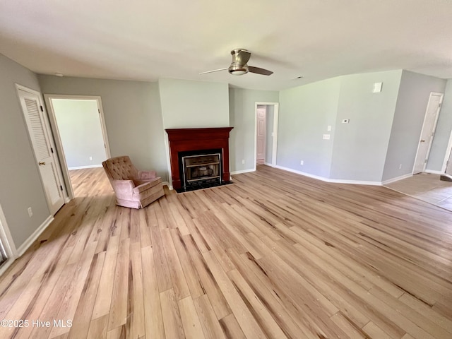 2940 Mulberry Ln Unit B, Greenville, NC 27858 - unfurnished living room featuring light wood-type flooring, a fireplace with flush hearth, and ceiling fan
