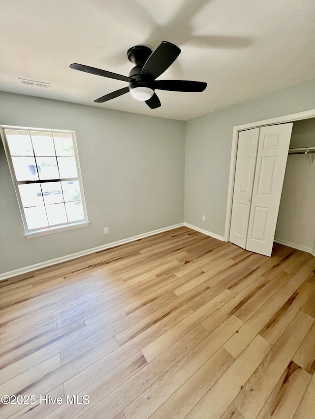 2940 Mulberry Ln Unit B, Greenville, NC 27858 - unfurnished bedroom with light wood-type flooring, a closet, and a ceiling fan