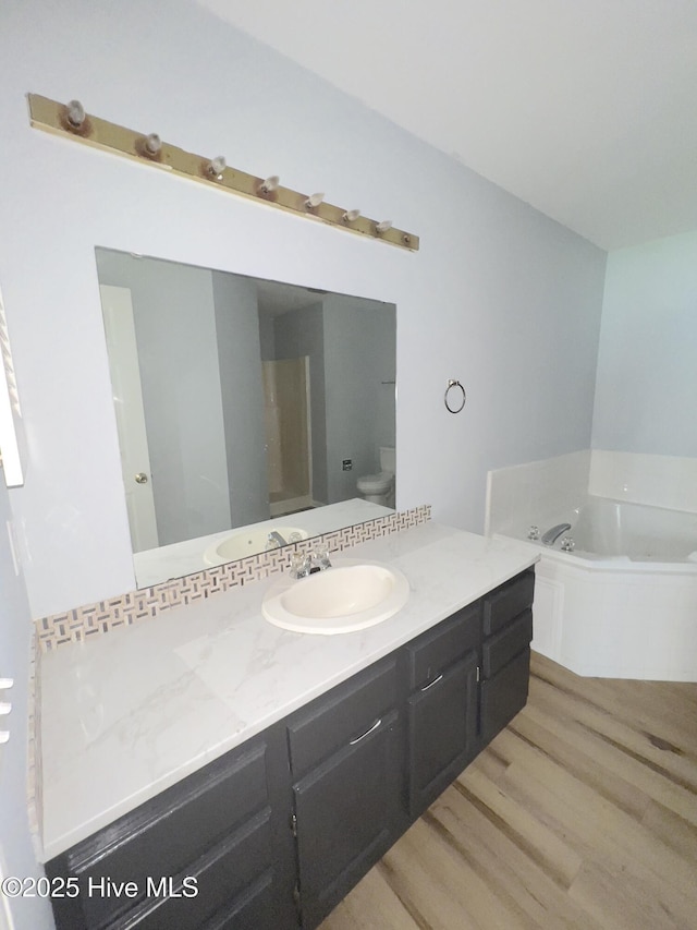 2940 Mulberry Ln Unit B, Greenville, NC 27858 - full bathroom with wood finished floors, vanity, and a garden tub