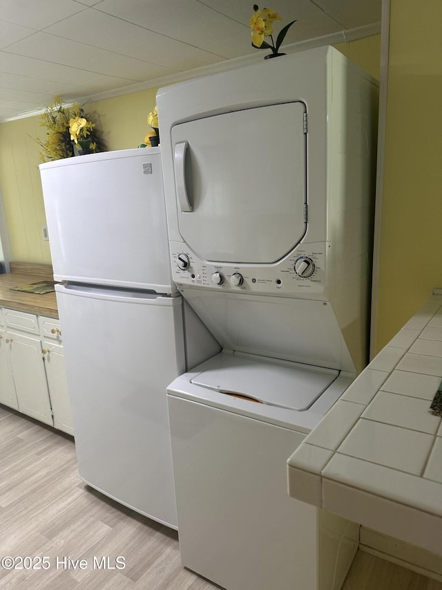 410 Brown Dr, New Bern, NC 28560 - laundry room featuring stacked washer / dryer and light wood-style floors