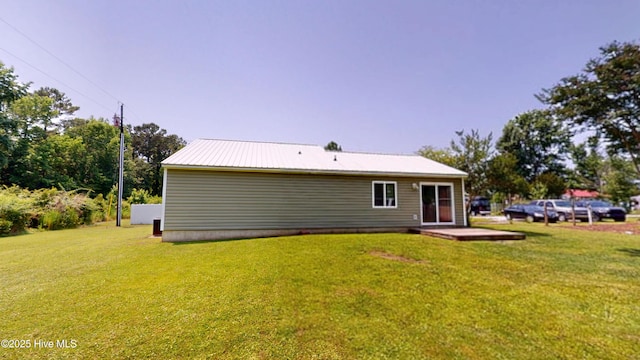 973 Ramsey Rd, Jacksonville, NC 28546 - rear view of property featuring a yard and a metal roof