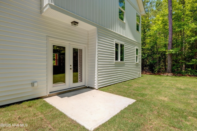 1536 Dorsey Ln, Navassa, NC 28451 - property entrance featuring french doors, a patio area, and a lawn
