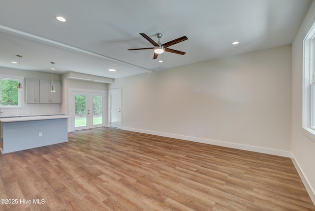 1536 Dorsey Ln, Navassa, NC 28451 - unfurnished living room featuring light wood-type flooring, ceiling fan, healthy amount of natural light, recessed lighting, and french doors