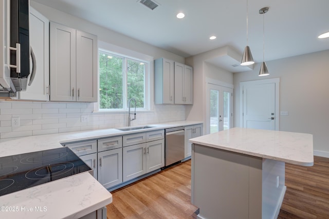 1536 Dorsey Ln, Navassa, NC 28451 - kitchen featuring dishwasher, light wood finished floors, tasteful backsplash, a kitchen island, and recessed lighting