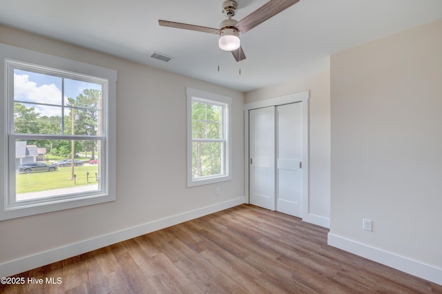 1536 Dorsey Ln, Navassa, NC 28451 - unfurnished bedroom featuring wood finished floors, a closet, and a ceiling fan