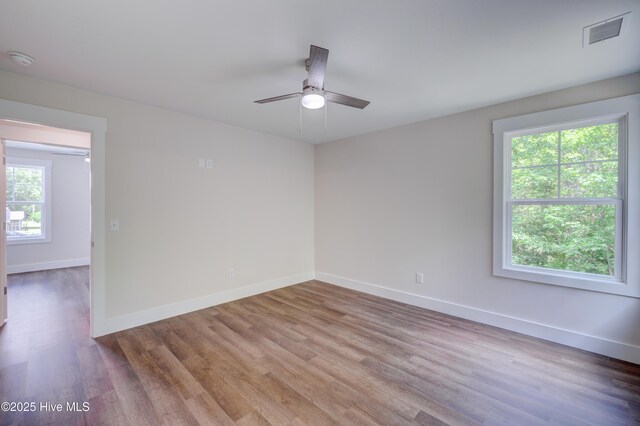1536 Dorsey Ln, Navassa, NC 28451 - spare room featuring wood finished floors, a ceiling fan, and a smoke detector