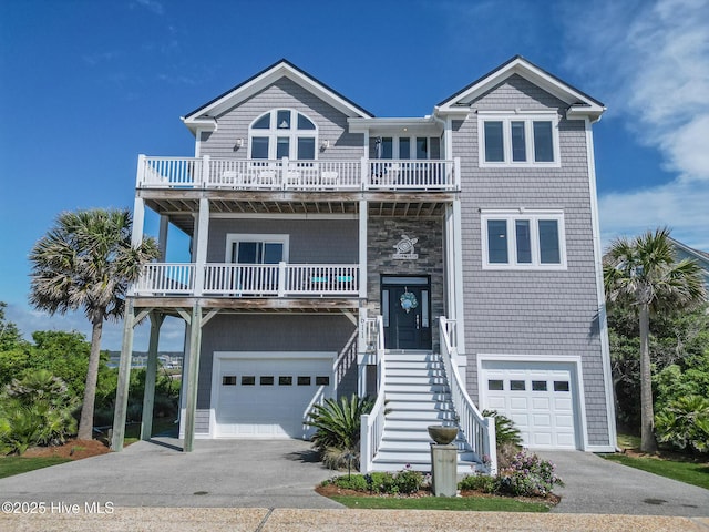 611 New River Inlet Rd, North Topsail Beach, NC 28460 - beach home with a balcony, an attached garage, and driveway