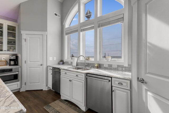 611 New River Inlet Rd, North Topsail Beach, NC 28460 - kitchen with stainless steel appliances, light countertops, glass insert cabinets, dark wood-style floors, and white cabinets