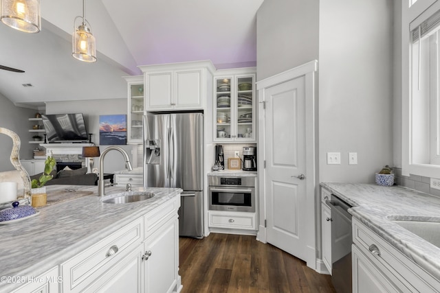 611 New River Inlet Rd, North Topsail Beach, NC 28460 - kitchen featuring appliances with stainless steel finishes, glass insert cabinets, vaulted ceiling, white cabinetry, and open floor plan