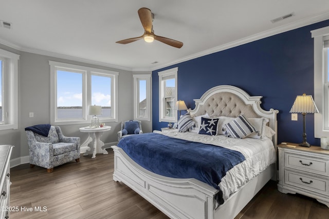 611 New River Inlet Rd, North Topsail Beach, NC 28460 - bedroom with dark wood-style floors, ornamental molding, and a ceiling fan